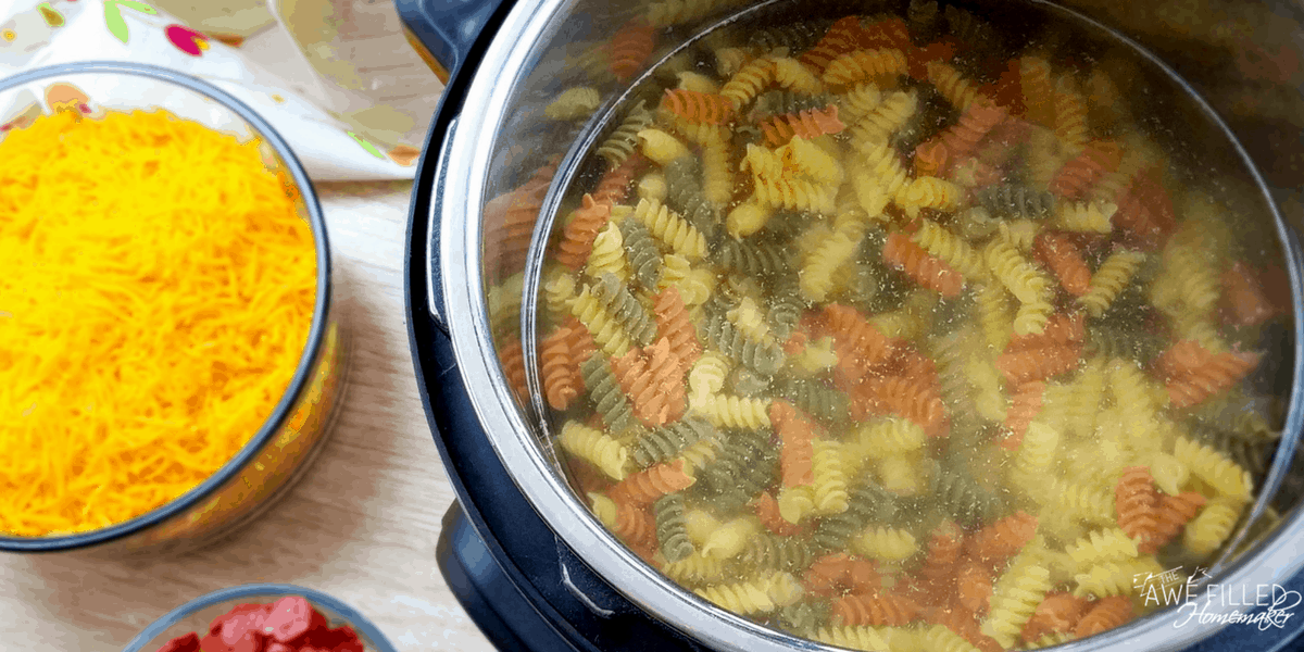 adding the noodles to the water in the instant pot 