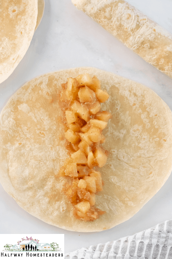 adding apple mixture to wrap 