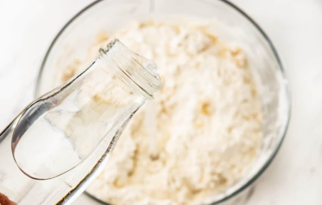 adding the water to the flour 