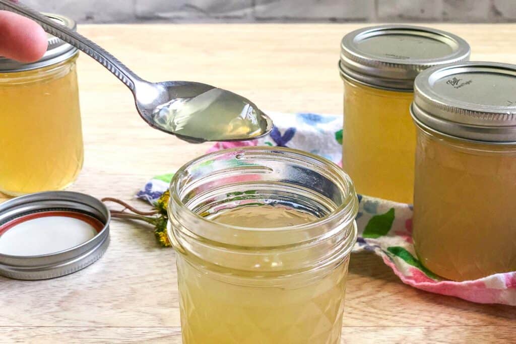 close up of spoon going into dandelion jelly 
